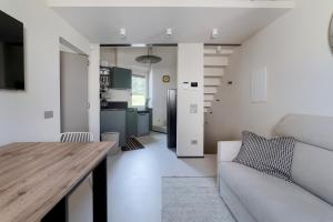 a kitchen and living room with a table and a couch at Luca's home over the Rose Garden in Florence