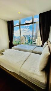 Ένα ή περισσότερα κρεβάτια σε δωμάτιο στο Vortex Suites Apartment Klcc Area