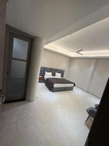 a bedroom with a bed and a sliding door at OVEL Hotel & RESORT in Ludhiana
