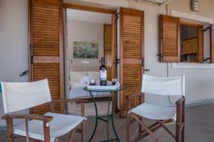 a room with a table and two chairs and a bed at Aloni Studios & Apartments in Athani