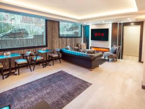 a living room with a couch and a tv at Modernlux Hotel in Istanbul
