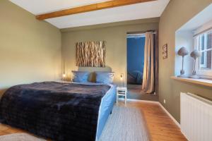 a bedroom with a large bed with blue sheets at Nordlichterhof in Neustadt am Rübenberge