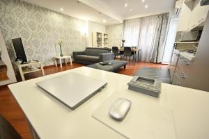 a living room with a couch and a table with a mouse at LA SUITE HOME - Central Apartment Deluxe in Civitavecchia +21 photos