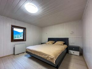 a bedroom with a bed in a room with a window at Vipche house in Verkhovyna