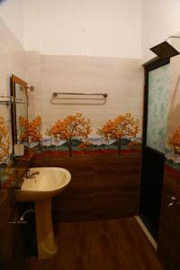 a bathroom with a sink and a window with trees at Rainbow Villa in Mahiyangana