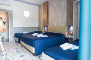 En eller flere senge i et værelse på Coral Beach Paestum + 13 billeder