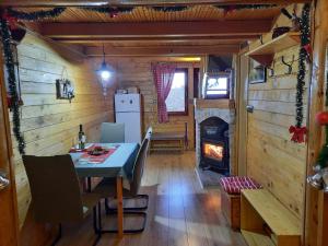 a dining room with a table and a fireplace at Chalet Woody in Stara Sušica +41 photos