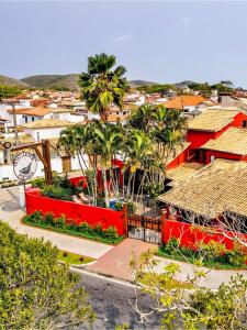 an aerial view of a city with palm trees and houses at Pousada Villegaignon in Búzios