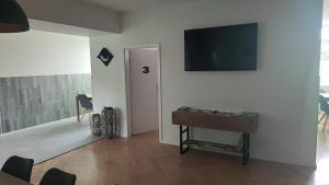 a living room with a flat screen tv on a wall at Pension HoPeLa in Gotha