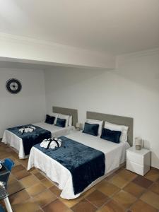 a bedroom with two beds with blue pillows at Alforra Residence 2-Centro-Praias-Levadas in Câmara de Lobos