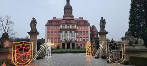 a large building with christmas decorations in front of it at Apartament Retro in Wałbrzych