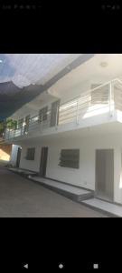 a white building with balconies on the side of it at Hotel la Bastilla in Sincelejo +7 photos