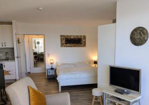 a living room with a bed and a television at Lord Nelson 715 in Döse