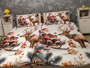 a bed with santa claus bedding in a room at Zeleni raj in Hreljin Ogulinski