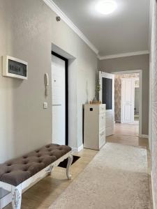 a large living room with a couch and a door at Сарыарка, 31 in Karagandy