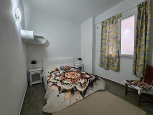 a bedroom with a bed and a window at La Casina in Follonica