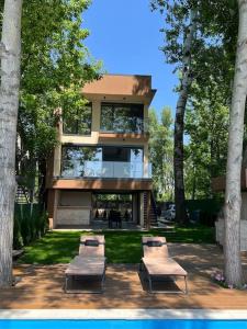 a building with three chairs in front of it at Riverhouse PIER in Beograd +30 photos