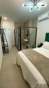 a bedroom with a bed with a ceiling fan at Beautiful Rooms Nº3 in Camas
