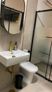 a bathroom with a sink and a toilet and a mirror at Beautiful Rooms Nº3 in Camas