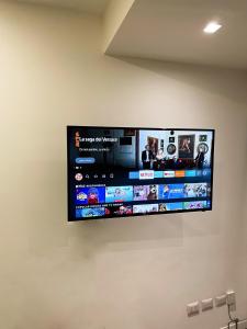 a flat screen tv hanging on a wall at Milano Lambrate 24h check in fully equipped in Milan