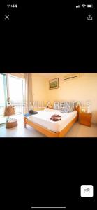 a bedroom with a large bed and a window at Villa 4 in Ayia Thekla in Ayia Napa