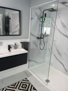 a bathroom with a shower and a sink at Bounty Town House Cumbria in Whitehaven +17 photos