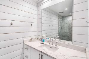 a white bathroom with a sink and a mirror at The Good Life in Inlet Beach +30 photos