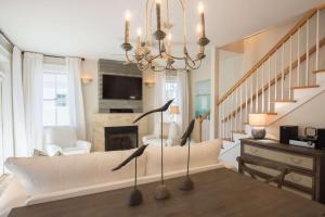 a living room with a couch and a fireplace at Beach Music in Rosemary Beach