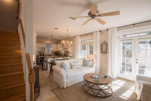 a living room with a white couch and a table at Beach Music in Rosemary Beach
