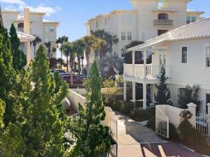 a large white building with trees in front of it at Beach Music in Rosemary Beach