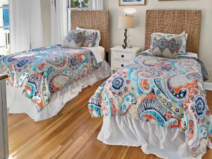 two beds sitting next to each other in a bedroom at Beach Music in Rosemary Beach +42 photos