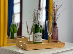 two bottles of champagne and glasses on a table at Apartamentos La Mina de Viñón. in Santa Eulalia
