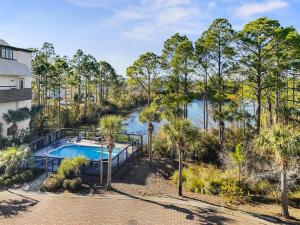 an aerial view of a swimming pool and trees at Moonstruck in Santa Rosa Beach