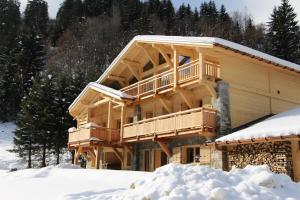 a log cabin in the snow with snow around it at Chalet Caméline in Les Contamines-Montjoie