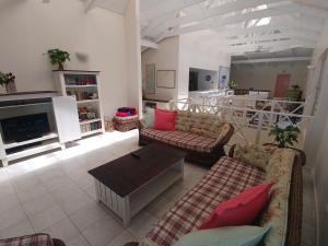 a living room with two couches and a coffee table at The Green Gate in Zinkwazi Beach