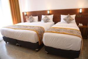 Postel nebo postele na pokoji v ubytování Ceylon Ayu Resort Kandy + 26 fotografií