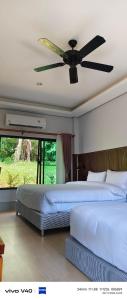 Postel nebo postele na pokoji v ubytování Mookies Bungalows
