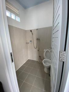 a bathroom with a toilet and a shower at Si Jalak Guest House By ARBA in Lebakwangi +16 photos