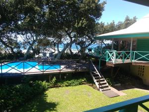 a house with a swimming pool next to a house at The Green Gate in Zinkwazi Beach
