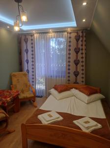 a bedroom with a bed with two towels on it at Willa Ewa in Poronin