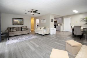 a living room with a couch and a dining room at Entire Magill House by RiverPark in Fresno