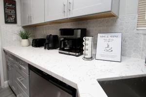 a kitchen counter with a microwave and a sign on it at Entire Magill House by RiverPark in Fresno