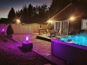 a lit up backyard at night with a candle at Cairnyard Lodges - Woodside in Beeswing