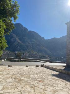 a stone patio with a view of a mountain at Casa Behar in Kotor