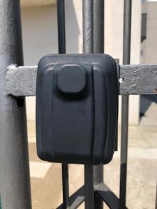 a black object is attached to a metal fence at Il Caravaggio Guest House 2 in Grassobbio