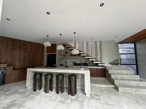a kitchen with a counter and some stairs at Aranya Bali in Tumbak Bayuh