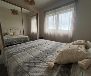 a bedroom with a large bed and a large mirror at A Casa da Moucha in Muxia