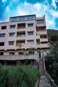 a tall building with a staircase in front of it at Bab Atas appartment N4 in Ourika Valley in Marrakech