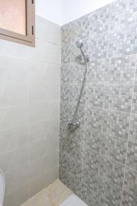 a shower in a bathroom with a tiled wall at Bab Atas appartment N4 in Ourika Valley in Marrakech +13 photos