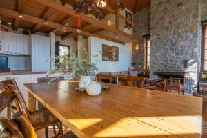 a kitchen and dining room with a wooden table at Winter Breeze in Arachova